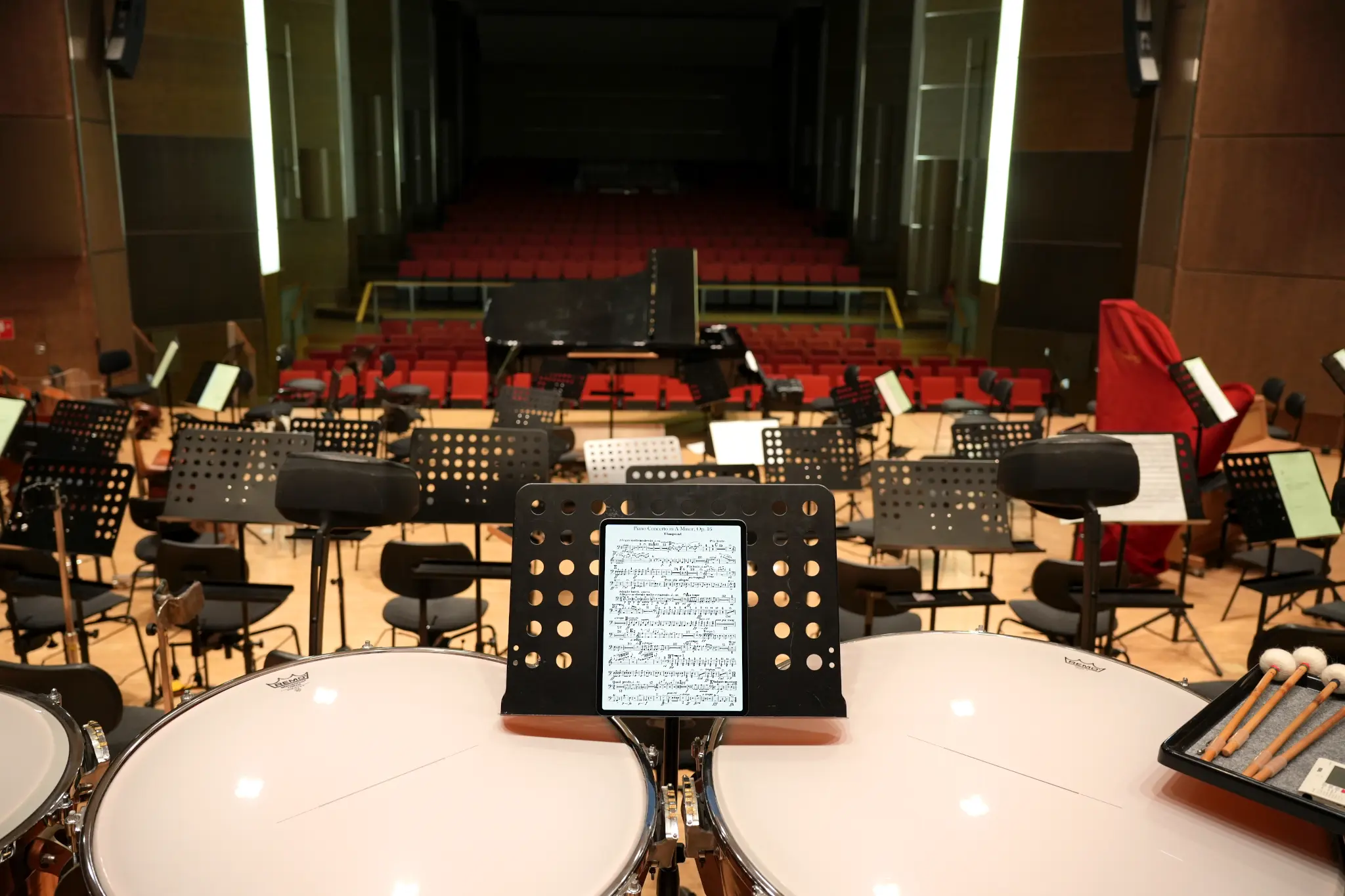 The best iPad for sheet music: iPad with sheet music on a music stand, as seen from the timpani in an orchestra.